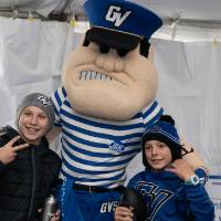 louie the laker poses with two boys